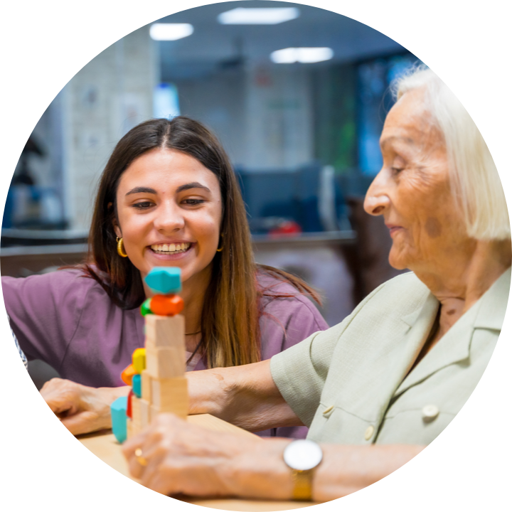 senior woman and her granddaughter doing an activity involving blocks